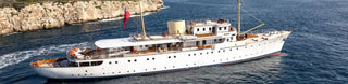 Elegant white yacht with classic design featuring reliable sensors on blue waters.