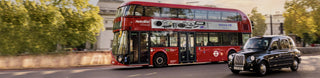 Red double-decker bus on city street showcasing Wema Truck fuel level measurement.