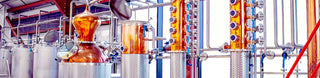 Copper distillation equipment showcasing gleaming tanks for industrial applications.