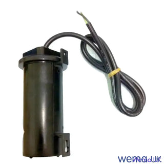 Cylindrical black capacitor with wires for Leakage Alarm Sender product assembly